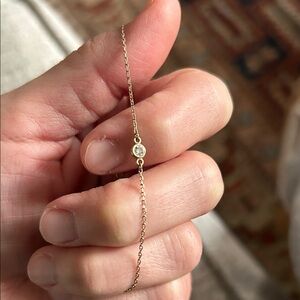14 kt gold diamond solitaire floating bracelet.
